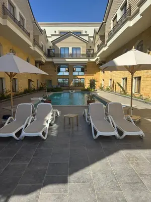 a group of chairs and umbrellas next to a pool at 304 aqua blue bay in Hurghada