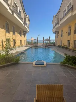 a swimming pool in a courtyard between two buildings at 304 aqua blue bay in Hurghada