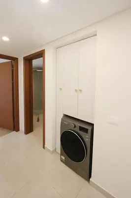 a kitchen with a washer and dryer in a room at The View Hurghada Poolfront Sea View Apartment in Hurghada
