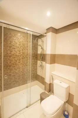 a bathroom with a toilet and a shower at The View Hurghada Poolfront Sea View Apartment in Hurghada