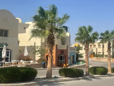 a group of palm trees in front of a building at Casa Seherezade in Hurghada