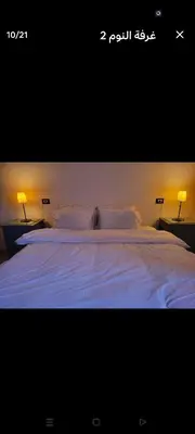 a large bed with white sheets and pillows at Casablanca guest house᭄ꦿ in Luxor