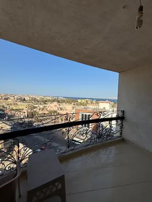 a balcony with a view of a city at Bahia Hurghada - 2 Bedrooms Serviced Apartment - City view in Hurghada