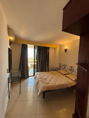 a bedroom with two beds and a large window at Bahia Hurghada - 2 Bedrooms Serviced Apartment - City view in Hurghada