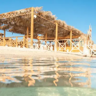 a resort with a thatched roof on the beach at Bahia Hurghada - 2 Bedrooms Serviced Apartment - City view in Hurghada