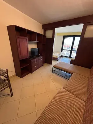 a living room with a couch and a television at Bahia Hurghada - 2 Bedrooms Serviced Apartment - City view in Hurghada