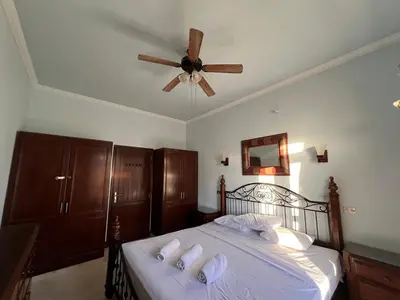 a bedroom with a bed with a ceiling fan at Waterfront Sabina I 4Bdr Retreat - Heated Pool in Hurghada