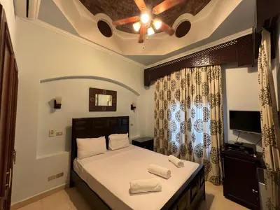 a bedroom with a bed with two towels on it at Waterfront Sabina I 4Bdr Retreat - Heated Pool in Hurghada