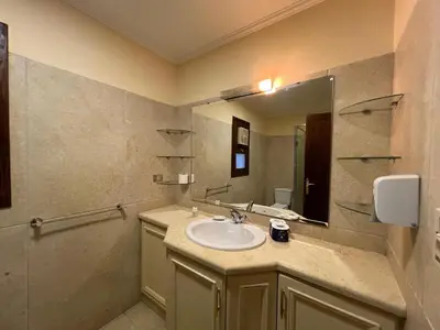 a bathroom with a sink and a mirror at Waterfront Sabina I 4Bdr Retreat - Heated Pool in Hurghada