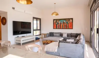 a living room with a couch and a tv at Premium 5BR Villa • Heated Pool • Ancient Hill in Hurghada