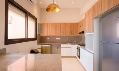 a kitchen with white cabinets and a large window at Premium 5BR Villa • Heated Pool • Ancient Hill in Hurghada