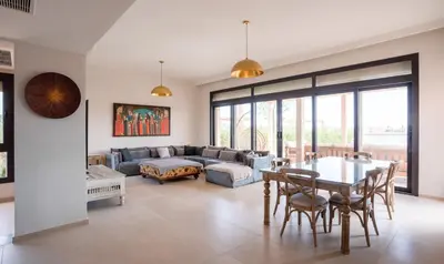 a living room with a table and a couch at Premium 5BR Villa • Heated Pool • Ancient Hill in Hurghada