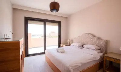 a bedroom with a bed and a large window at Premium 5BR Villa • Heated Pool • Ancient Hill in Hurghada