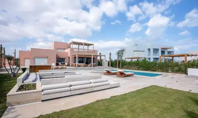 a house with a patio with couches and a pool at Premium 5BR Villa • Heated Pool • Ancient Hill in Hurghada