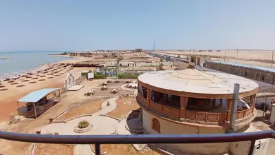 a building on the beach next to a beach at Casablanca beach in Hurghada