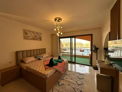 a bedroom with a bed and a balcony at The View Hurghada in Hurghada