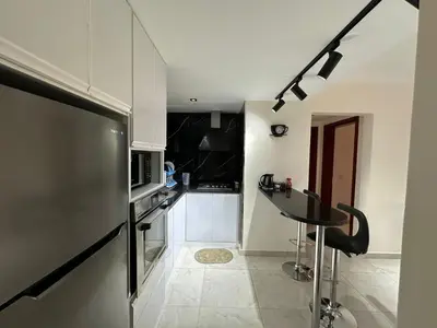 a kitchen with a stainless steel refrigerator and a table at The View Hurghada in Hurghada