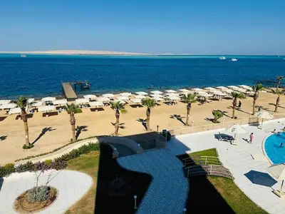 a view of a beach with a pool and umbrellas at The View Hurghada in Hurghada
