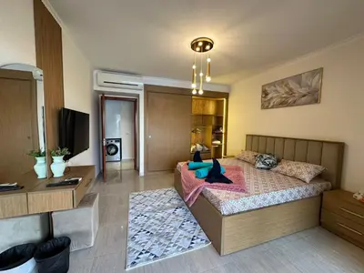 a bedroom with a bed and a desk in it at The View Hurghada in Hurghada