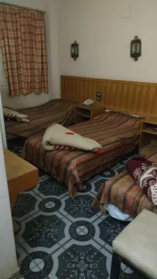a hotel room with two beds and a carpet at New mostafa hotel in Luxor