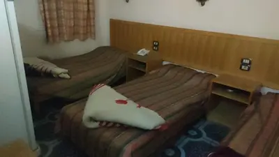 a hotel room with two beds in a room at New mostafa hotel in Luxor