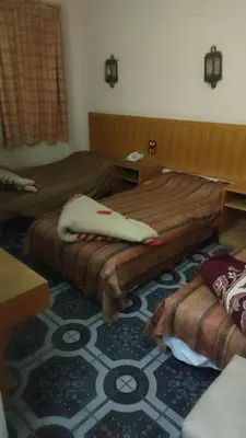 a hotel room with two beds and a carpet at New mostafa hotel in Luxor