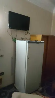 a television on top of a refrigerator in a room at New mostafa hotel in Luxor