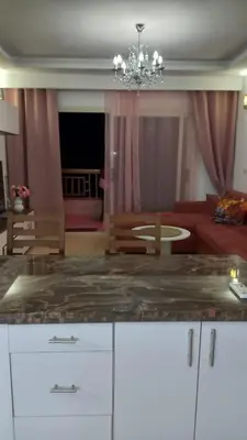 a living room with a couch and a chandelier at Palma chalet 169 in Hurghada