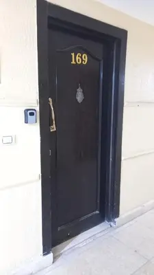 a black door with the number on it at Palma chalet 169 in Hurghada