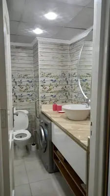 a bathroom with a sink and a toilet and a mirror at Palma chalet 169 in Hurghada