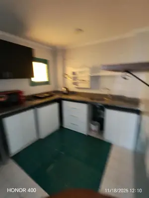 a room with a kitchen with a green floor at Elixir Two Bed Rooms in Hurghada