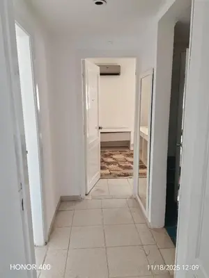 an empty hallway with white walls and a white door at Elixir Two Bed Rooms in Hurghada