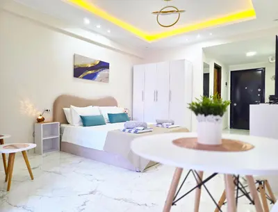 a bedroom with a bed and a table at Pool Dream Hurghada in Hurghada