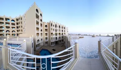 a view of the beach from the balcony of a building at Pool Dream Hurghada in Hurghada