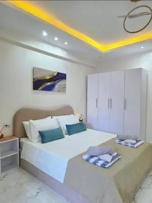 a bedroom with a large bed with two towels on it at Pool Dream Hurghada in Hurghada