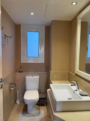 a bathroom with a toilet and a sink at The Nest Namaste - El Gouna in Hurghada