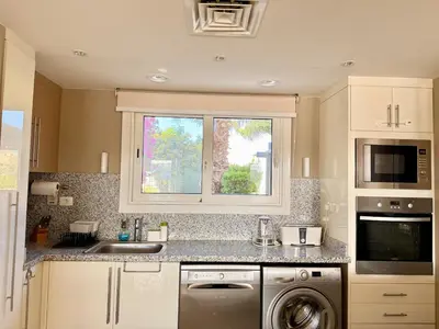 a kitchen with a sink and a washing machine at The Nest Namaste - El Gouna in Hurghada