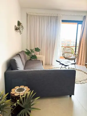 a living room with a couch and a table at Boho Beach Chalet in El Gouna with pool access in Hurghada