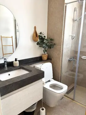a bathroom with a toilet and a sink and a shower at Boho Beach Chalet in El Gouna with pool access in Hurghada
