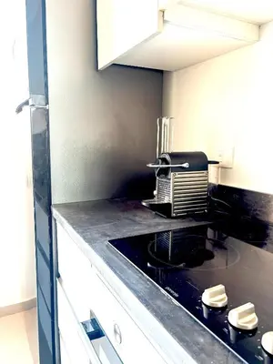 a kitchen with a black counter top with a appliance at Boho Beach Chalet in El Gouna with pool access in Hurghada