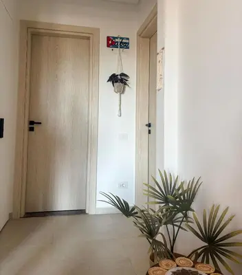 a hallway with a door and a potted plant at Boho Beach Chalet in El Gouna with pool access in Hurghada