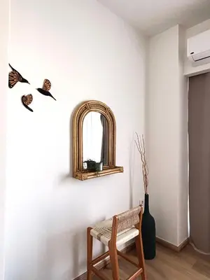 a room with a chair and a mirror on the wall at Boho Beach Chalet in El Gouna with pool access in Hurghada