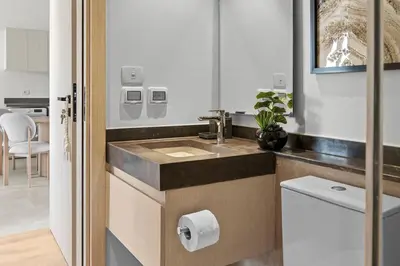a bathroom with a sink and a toilet paper dispenser at Posh Gouna Poolside in Hurghada