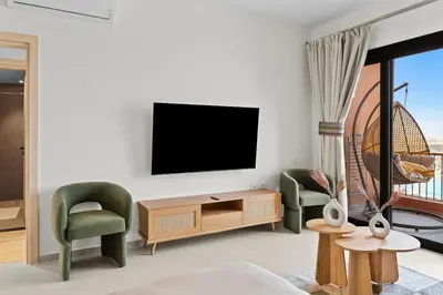 a living room with a flat screen tv on a wall at Posh Gouna Poolside in Hurghada