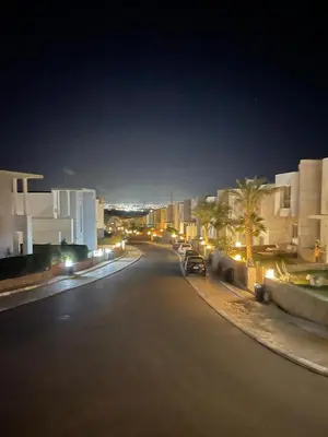 a city street at night with buildings and a car at Sky Star Villa 30 in Hurghada