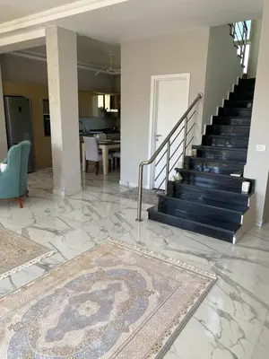 a living room with a staircase and a rug at Sky Star Villa 30 in Hurghada