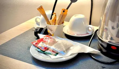 a table with a plate of food and a cup of utensils at Nile Hotel in Aswan