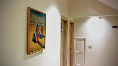 a painting hanging on a wall in a hallway at Nile Hotel in Aswan