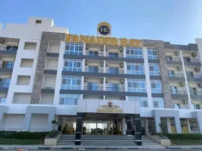a large building with a sign on top of it at fanadir resort in Hurghada