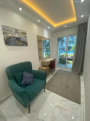 a living room with a green couch and a table at Fanadir Chalet 3BR in Hurghada